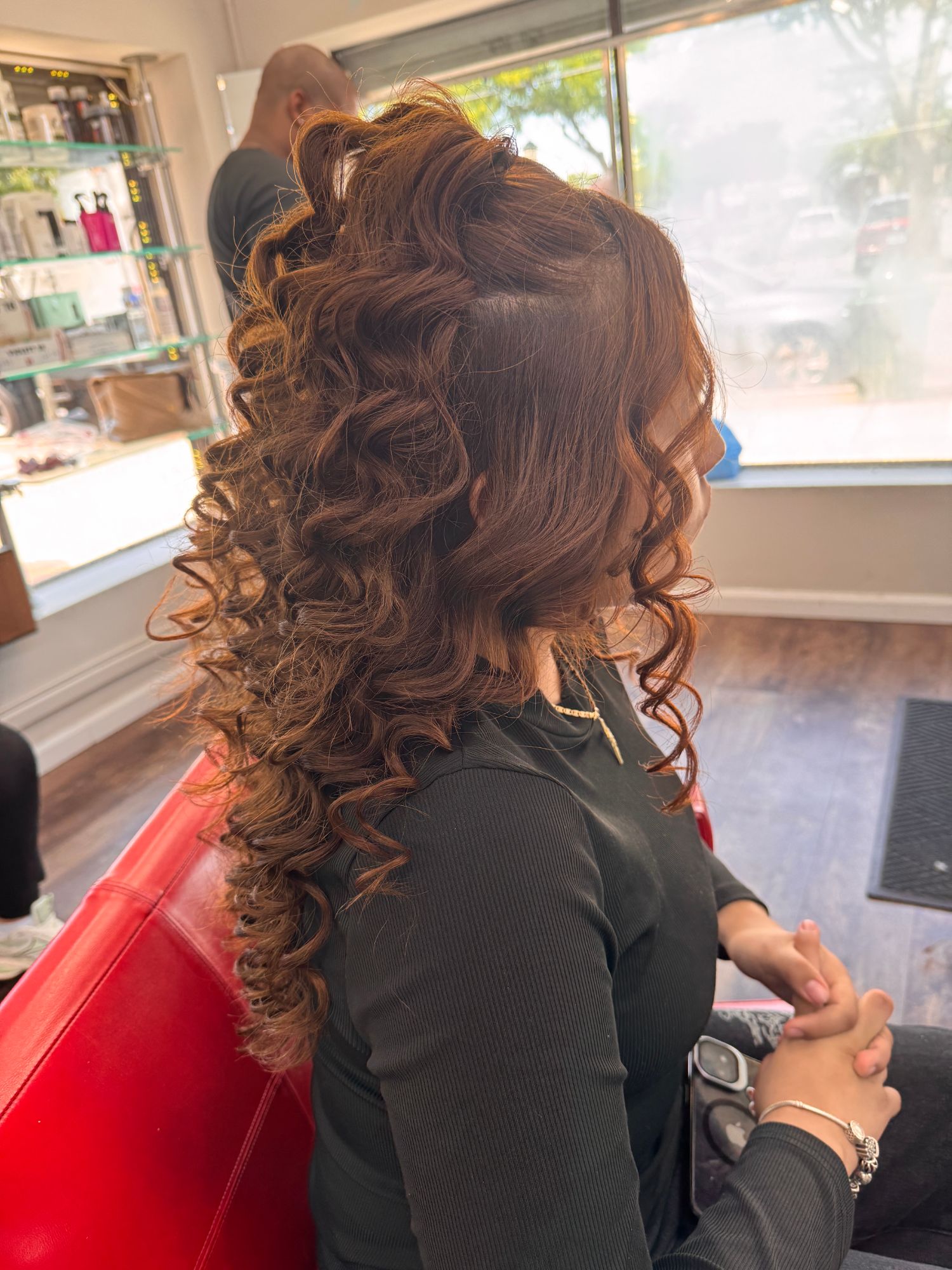 Auburn blowout with voluminous half-up curls